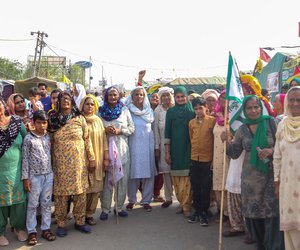 They rose with the sun. And there were smiles on the faces of women congregating early in the morning at Singhu, on the Haryana-Delhi border. Theye were there to commemorate International Women’s Day (IWD) on March 8, 2021, in response to a call given by the Samyukta Kisan Morcha (SKM), the collective of various farm unions coordinating the agitation. This year, IWD  coincided with the 100th day of the historic farmers’ protest – where the women are prominent participants – against the three farm laws imposed by the union government. 

Shanti, 80 years old (sixth from the left), with a blue scarf over her head and a white-red flag in her hand, came from Bitani village in Jind district of Haryana. “We do not ask for alms here. We are demanding our rights,” she said.