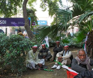 Farmers from Uttar Pradesh sitting quietly on a pavement at Parliament Street. They have come a long way from their villages to Delhi, marching in the hope that the government will waive their debts.