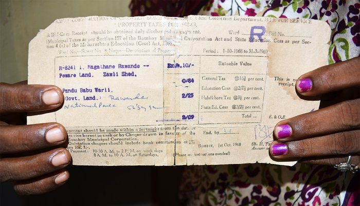 Asha Kaole showing her property tax receipts dating back to 1968