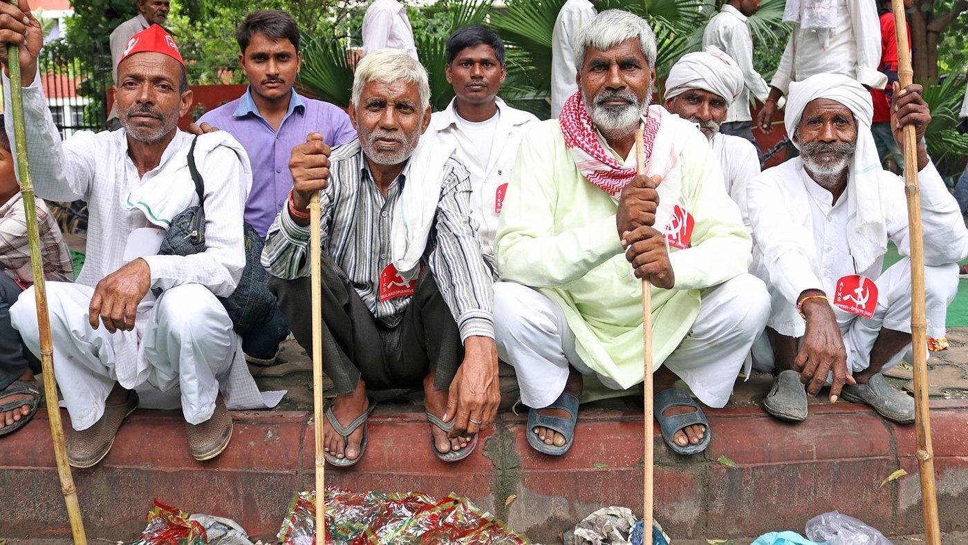 men sitting at a a protest rally