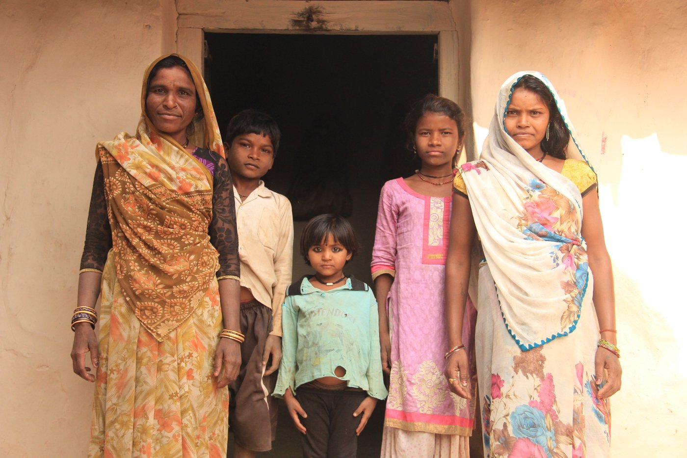 A family standing in front of their house 