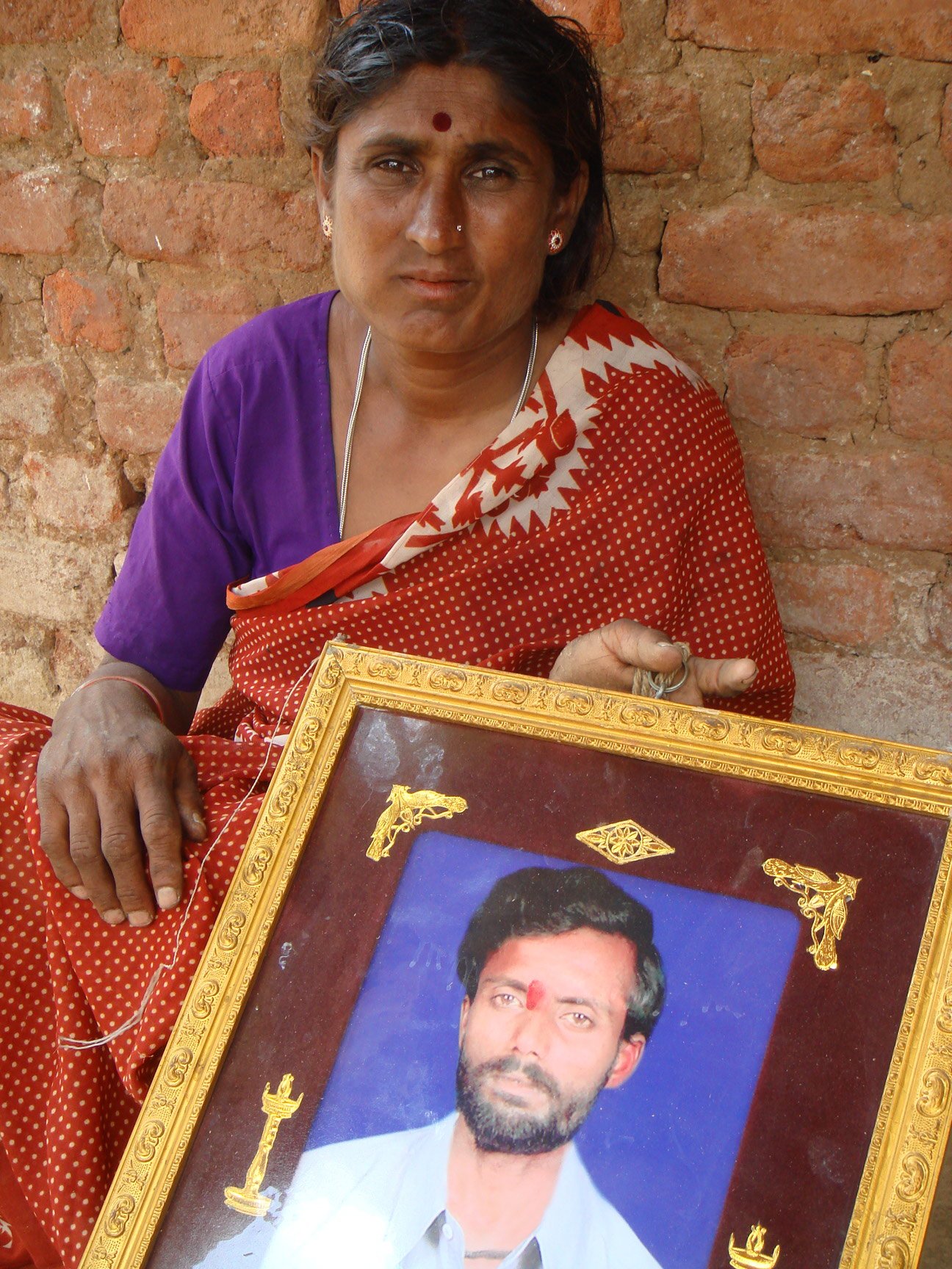 Woman with photo of her dead husband