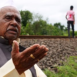 Close up of Ramchandra Sripati Lad with two men in the background