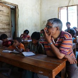 classroom full of boy students narrating poem