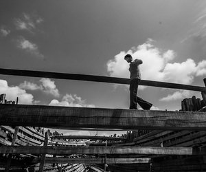 Man walking on a partially built ship