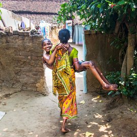 A women carrying her son