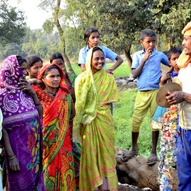 Tribal women of Bihar singing and dancing. Men playing the drums